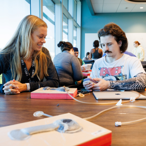 two students practicing healthcare skills